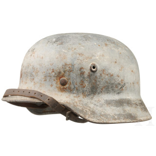 An army steel helmet M 40 with winter camouflage coating